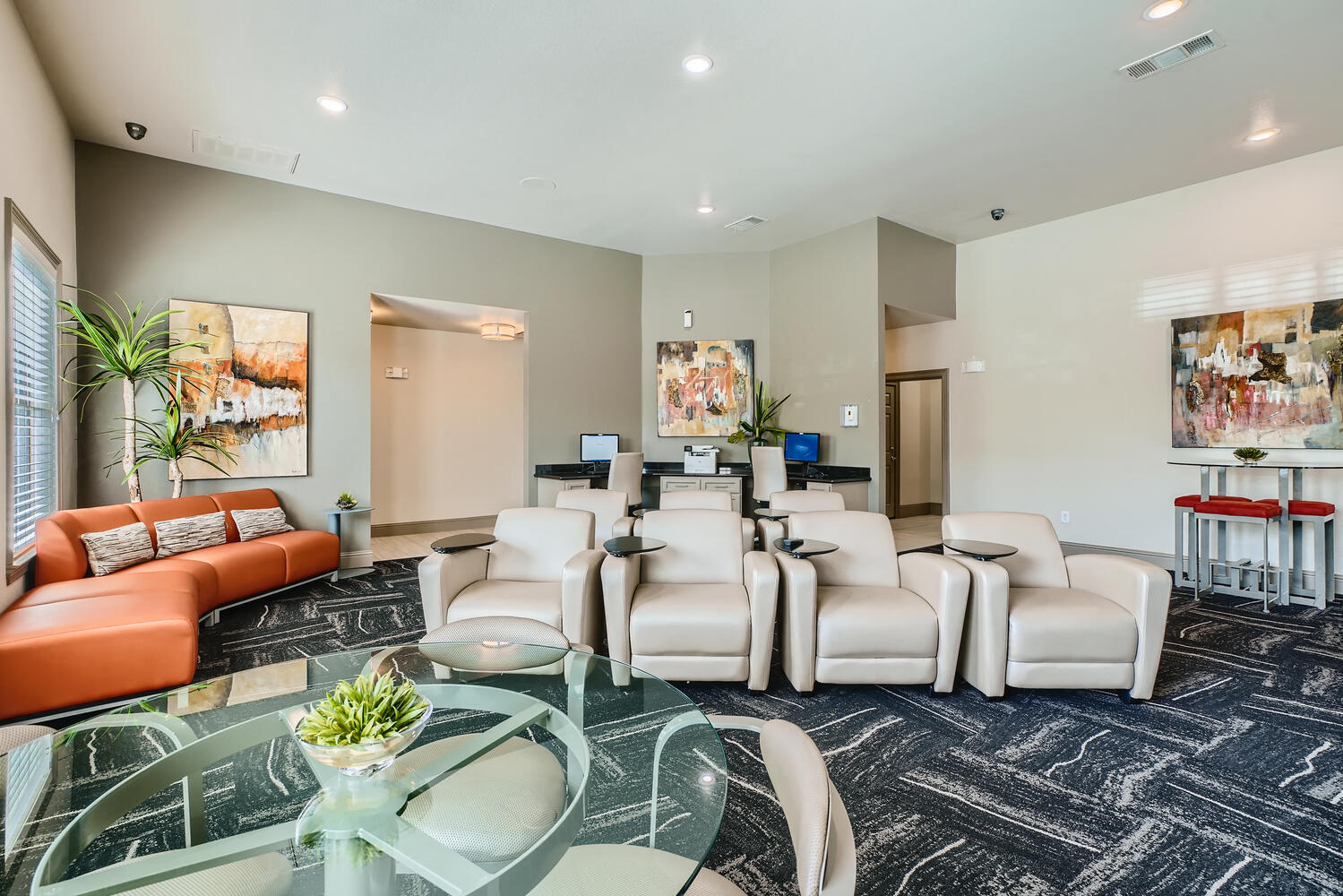 a living room with couches and chairs and a glass table